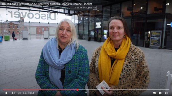 Zoe and Rachel stand outside Open Eye Gallery on this youtube preview