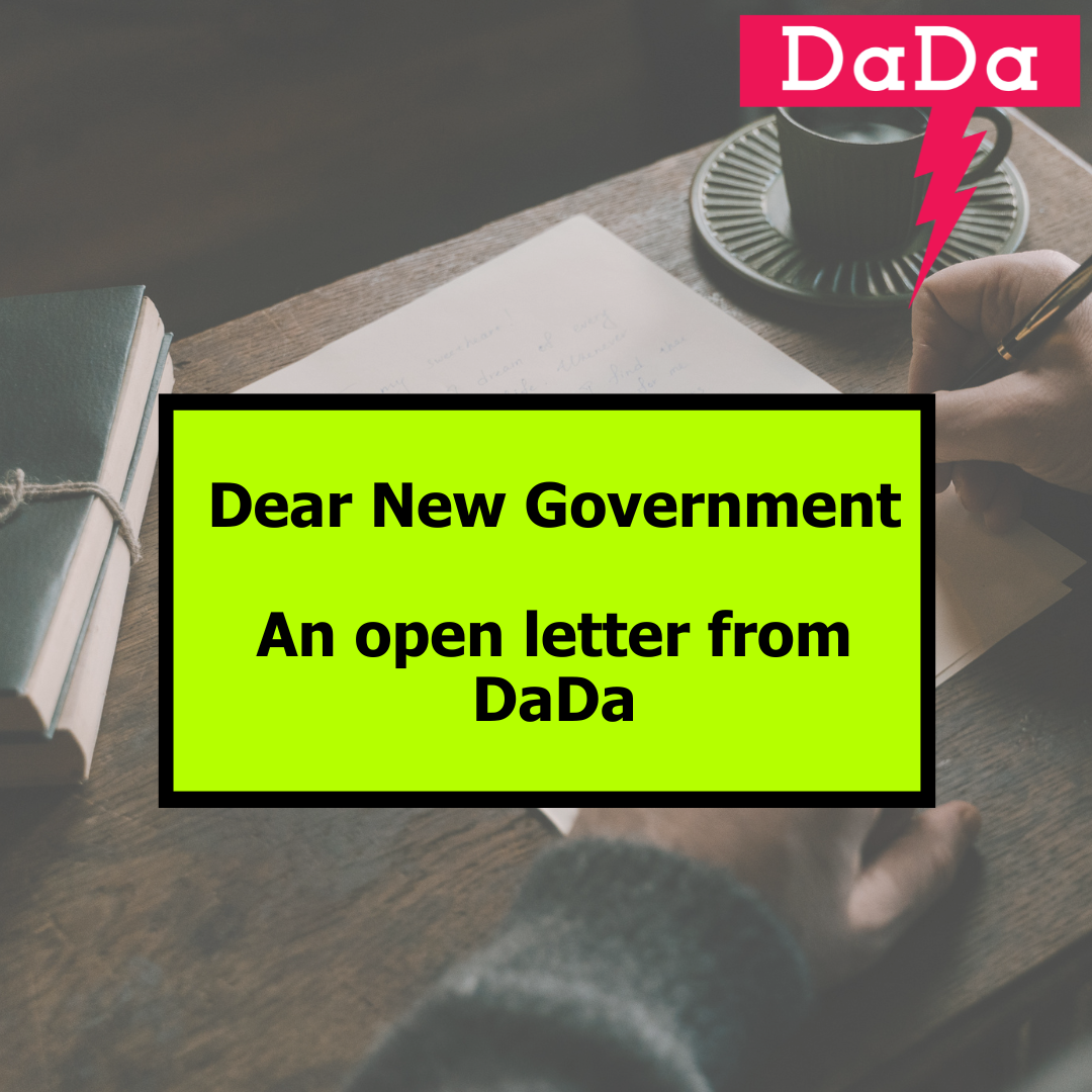 Someone leans over a desk with a pan in hand writing a letter. Words overlaid 'Dear New Government, An open letter from DaDa'