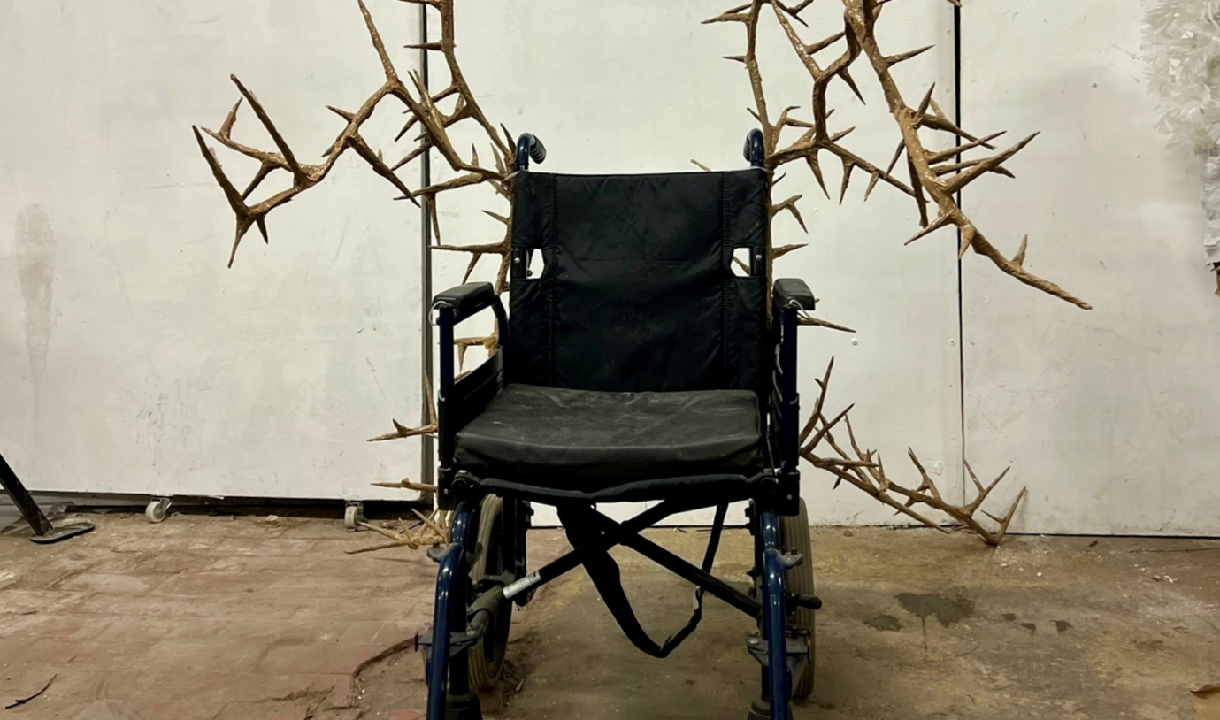 A wheelchair is covered in thorns. 