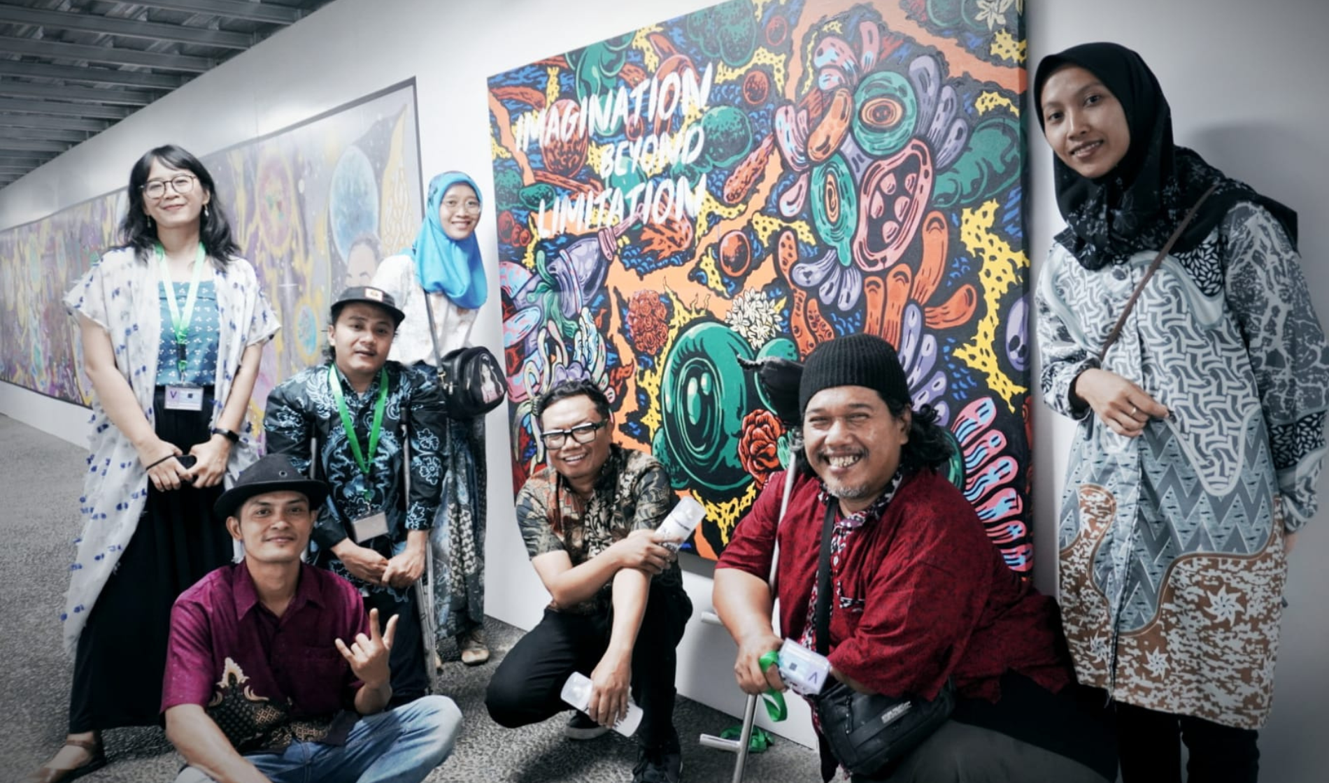 A group of people pose by street art